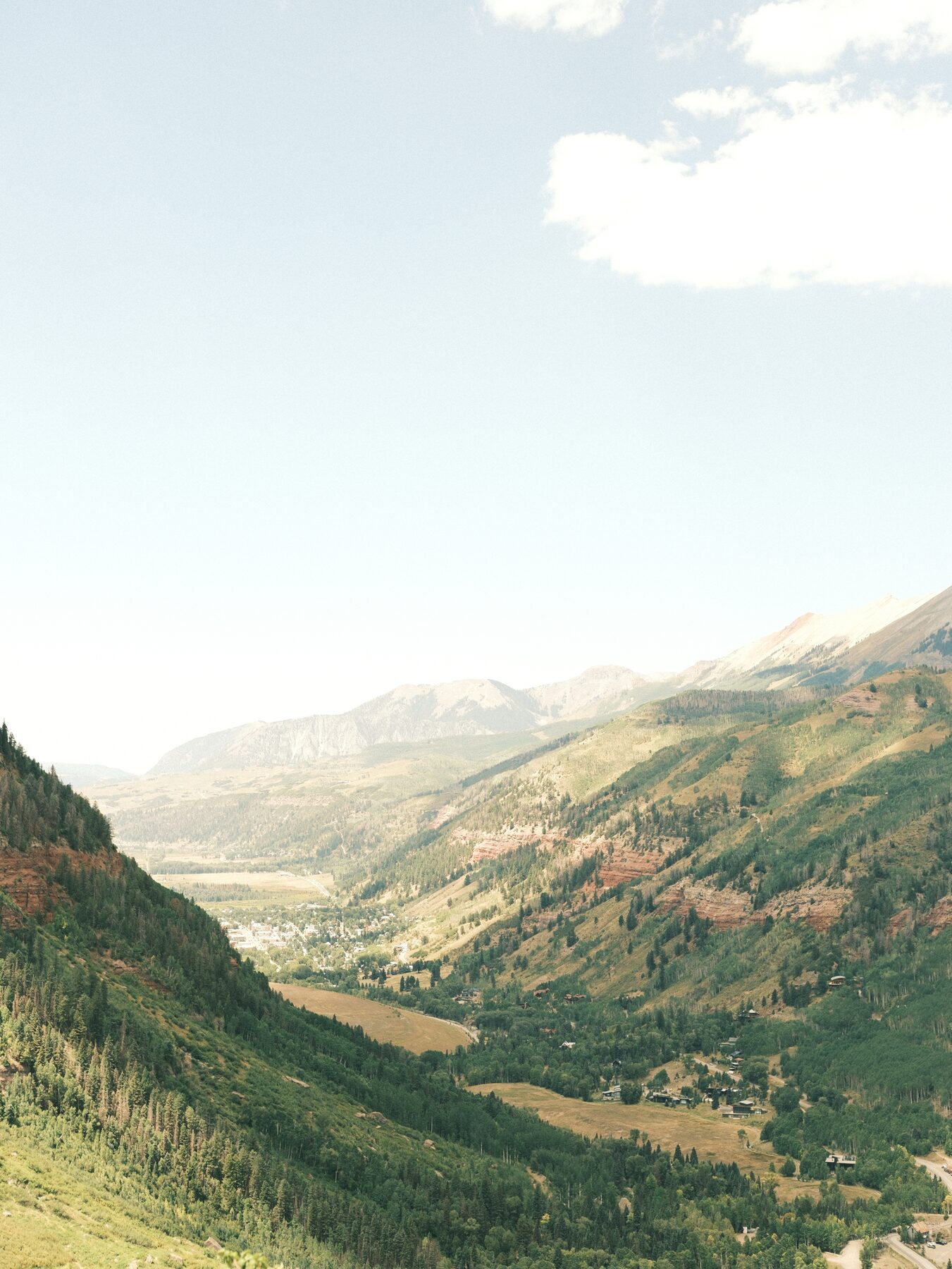 Green valley between steep mountain walls above Telluride, Colorado