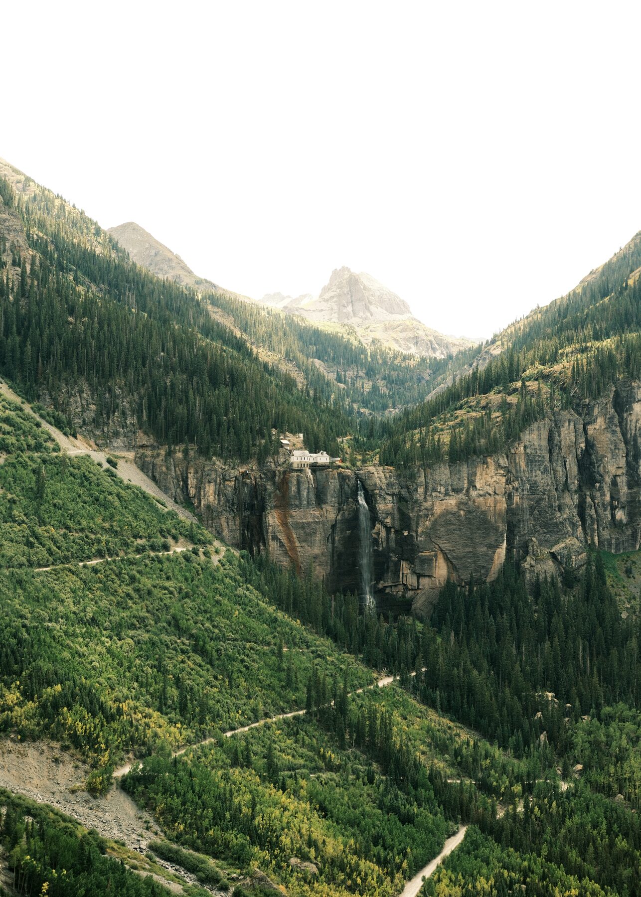 Switchbacks climbing toward a waterfall in a box canyon near Telluride